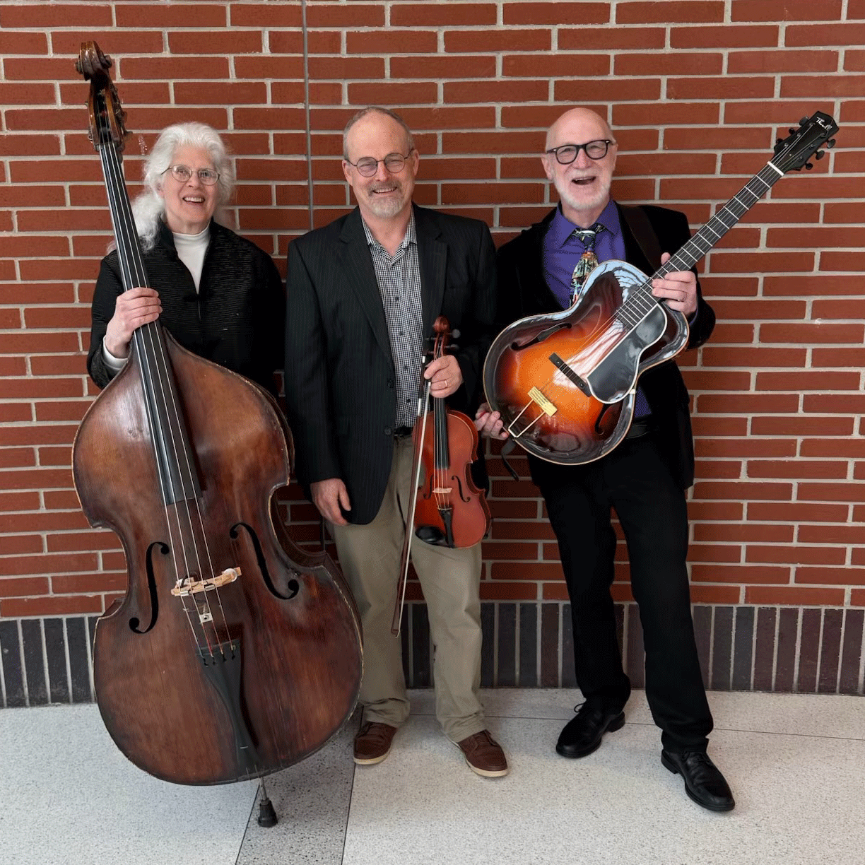 Three musicians pose with their instruments