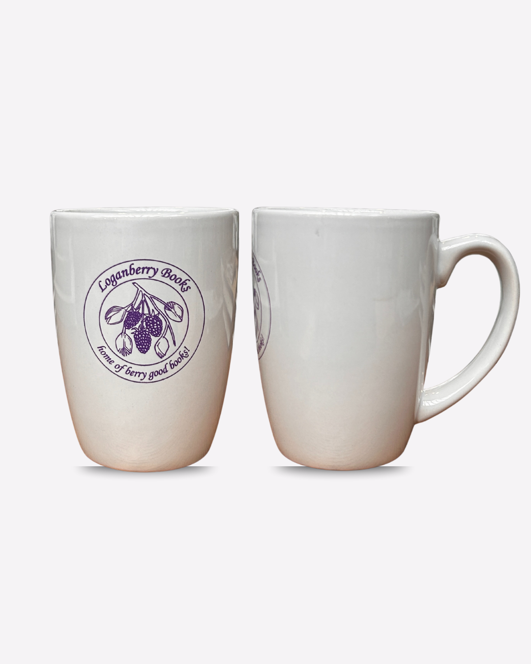 White Mug with purple image of berries and text reading LOGANBERRY BOOKS HOME OF BERRY GOOD BOOKS