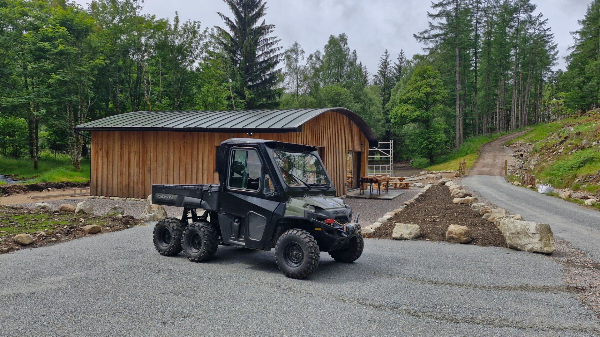 The Polaris 6 - Wheeled ATV, outside the recently landscaped ameinity building. The path on the right is the route up to the cabins.
