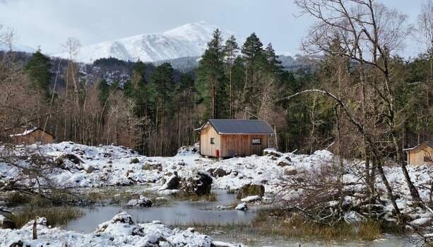 Spring snow at Glengarry Forest Cabins, with a snow covered Ben Tee in the distance.