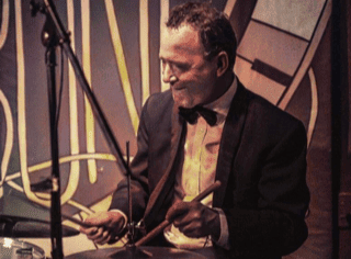 A photo of John Rae on the drums