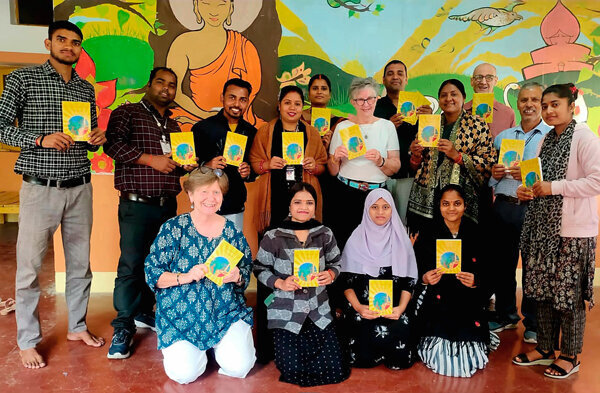 Ondy with her book, teachers, principal, Kabir, and Duffer