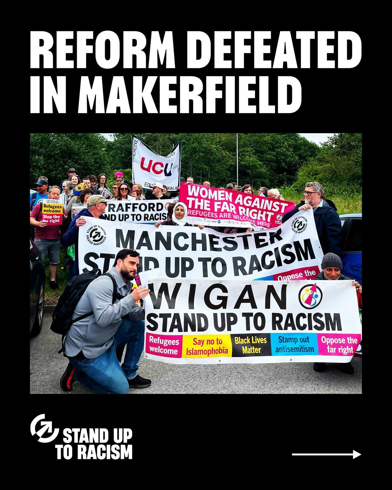 Image of Stand Up To RAcism activists from Wigan and Manchester with banners