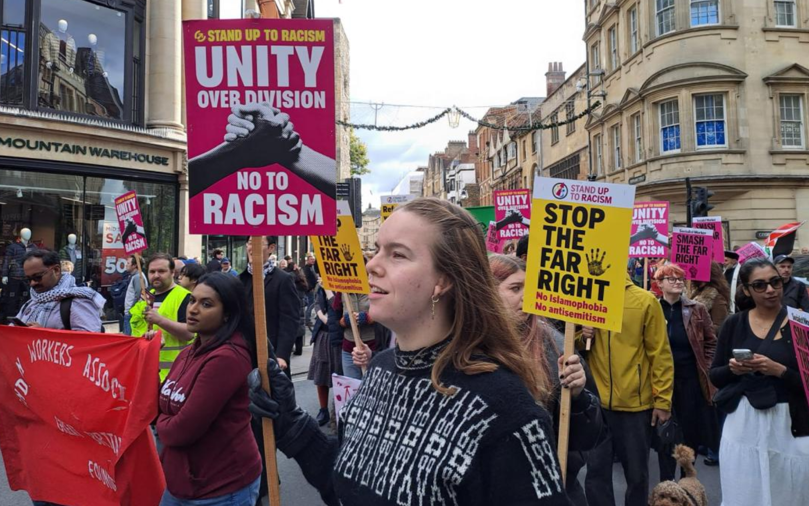 Oxford unity march -people with anti-racist placrads and banners pass through Cornmarket