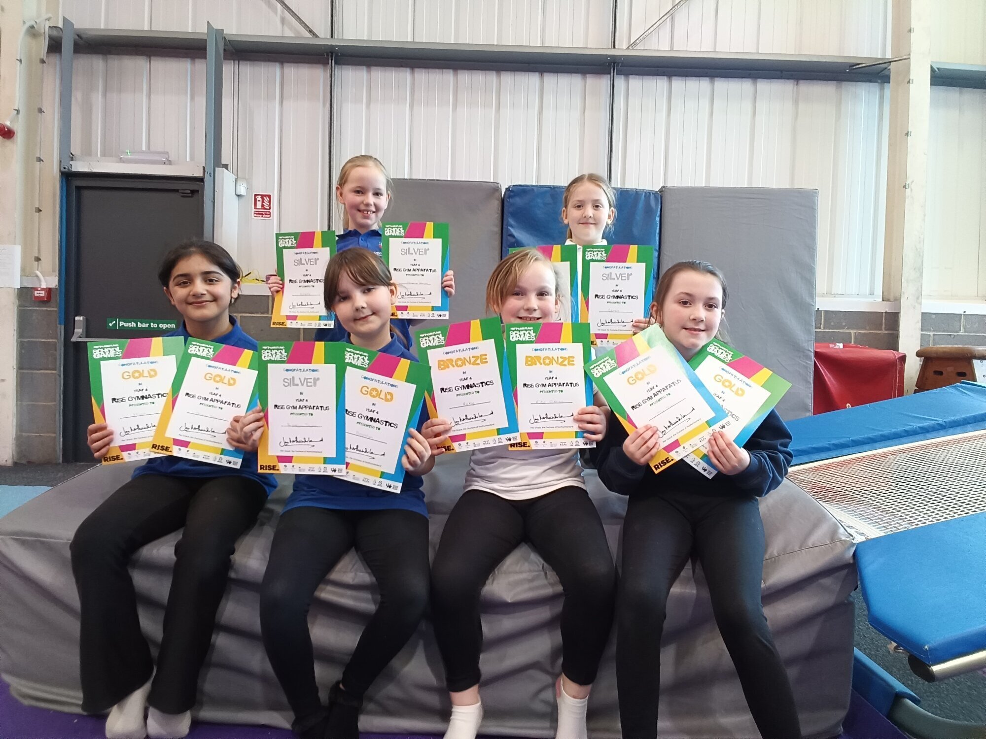 Six girls with their winning certificates.