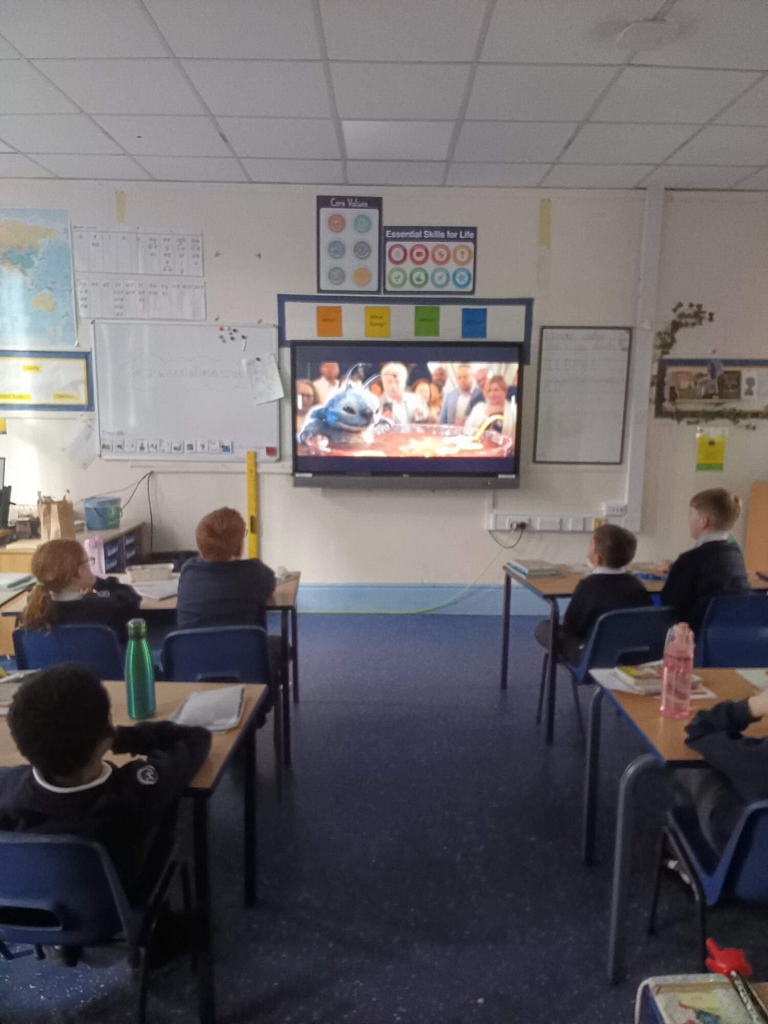 Children watching a film in class